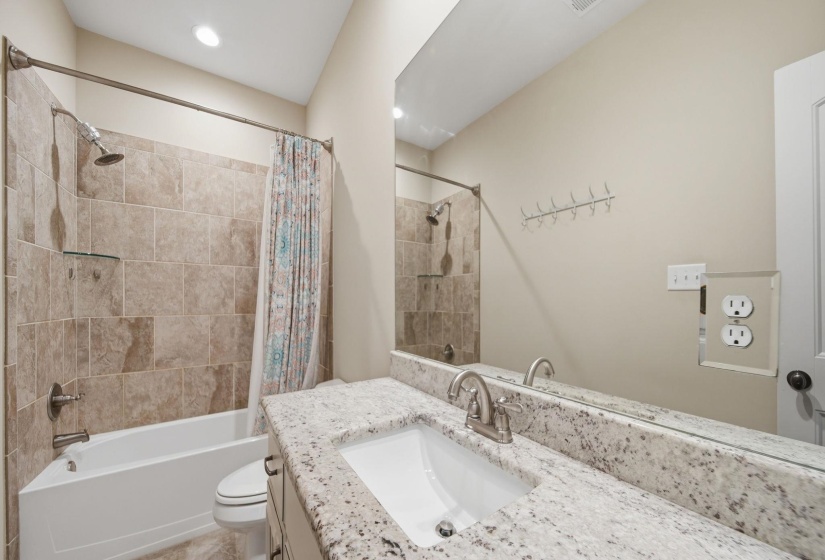 Full bath with vanity and shower / bath combo with shower curtain