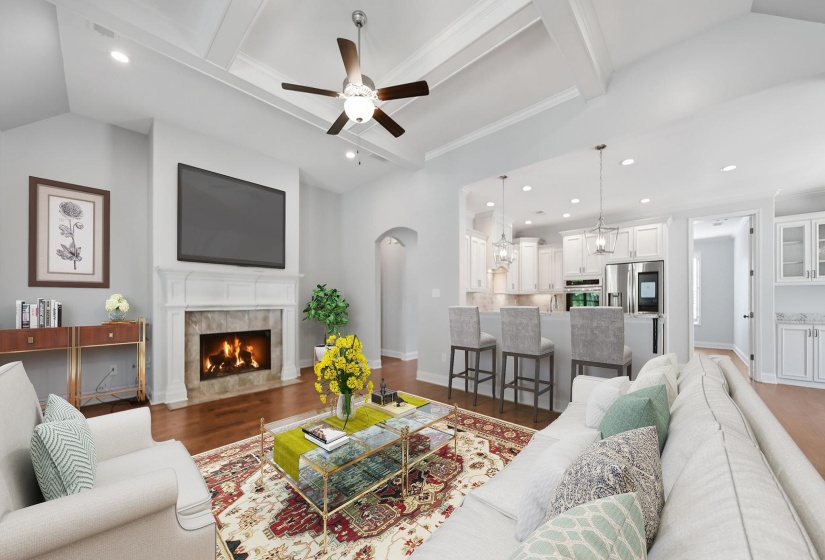 Living room featuring lofted ceiling with beams, recessed lighting, a ceiling fan, dark wood-style flooring, and a tile fireplace