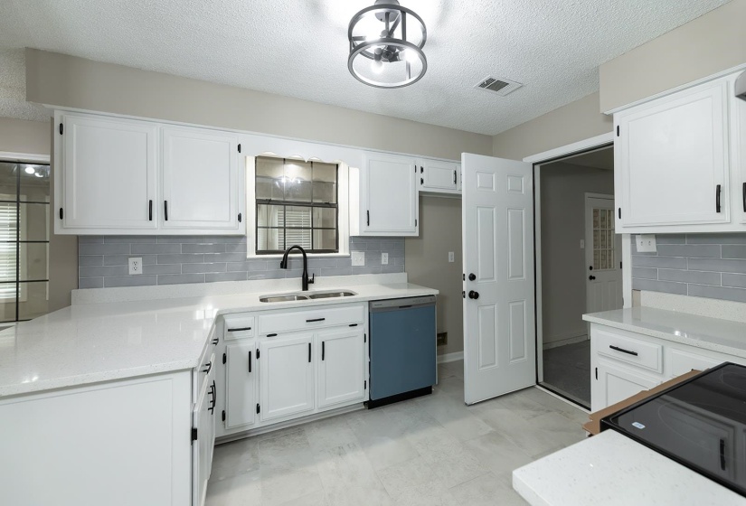 Kitchen featuring black / electric stove, dishwasher, white cabinets, decorative backsplash, and a textured ceiling