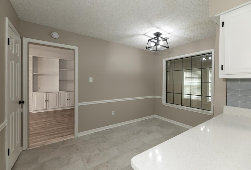 Unfurnished dining area with a textured ceiling