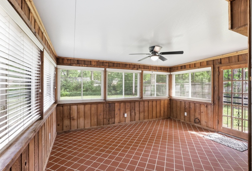 Unfurnished sunroom with wooden walls