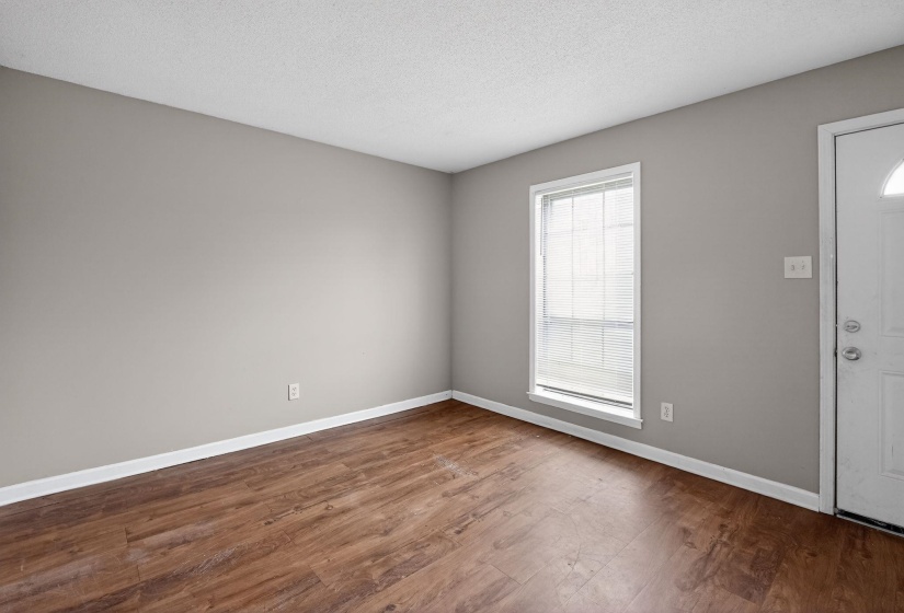 Foyer with dark wood finished floors and a textured ceiling