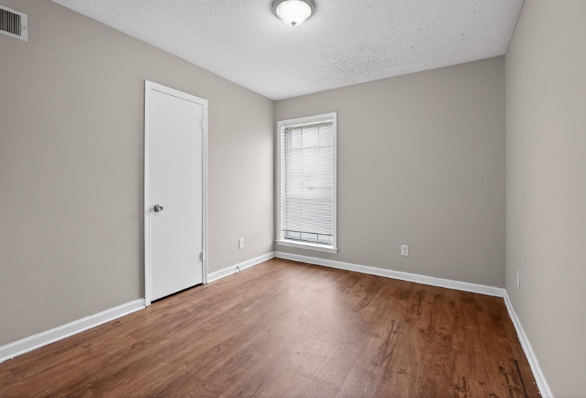 Spare room with a textured ceiling and dark wood finished floors