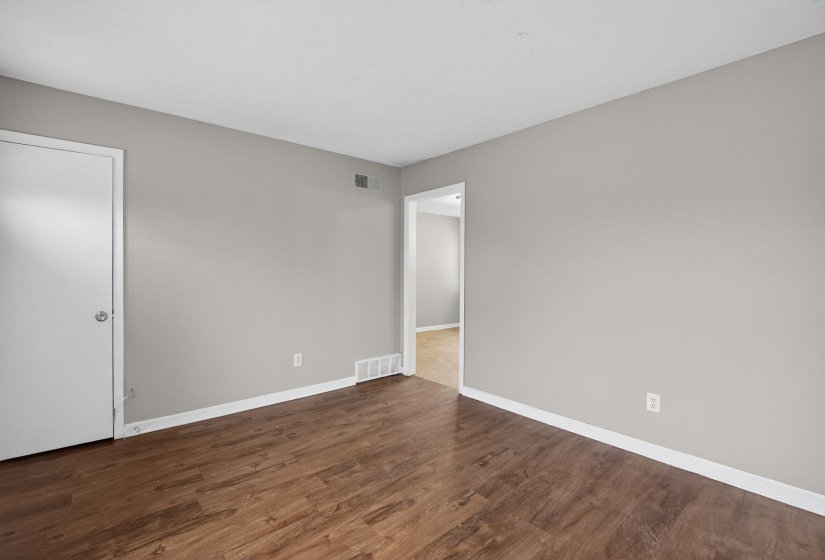 Unfurnished room with dark wood-style flooring and baseboards