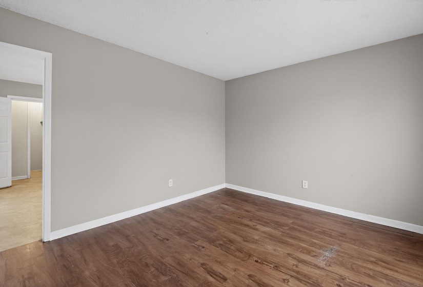 Unfurnished room with dark wood finished floors and baseboards