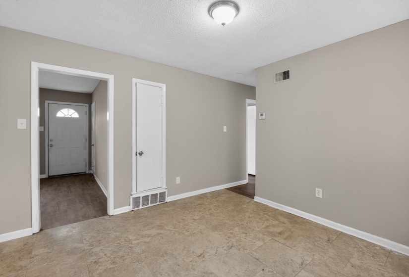 Empty room featuring baseboards and a textured ceiling
