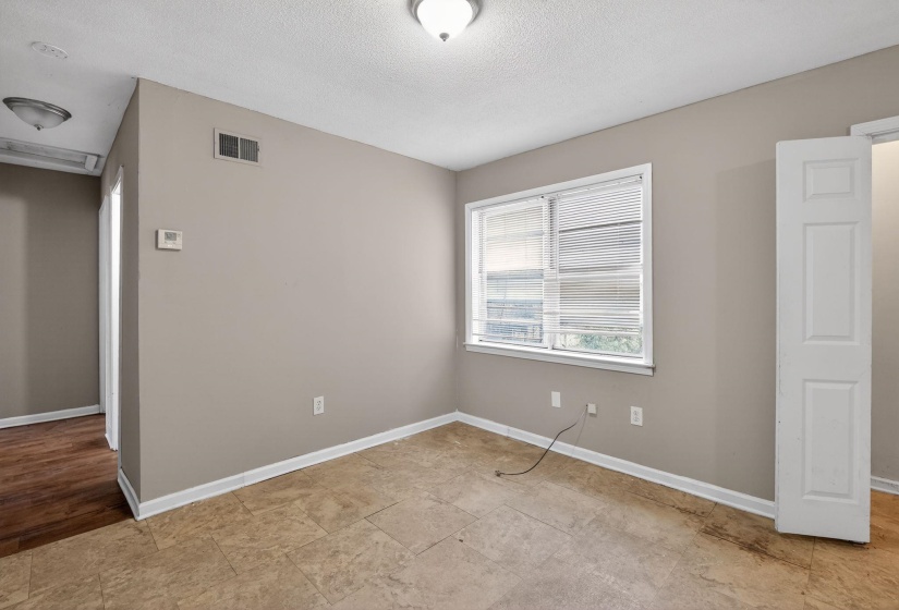 Unfurnished bedroom with a textured ceiling and baseboards
