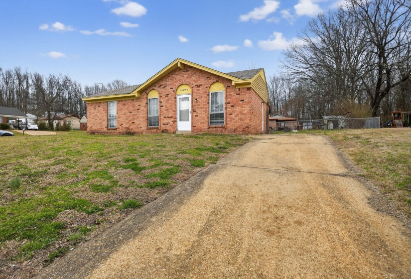 View of front of property featuring concrete driveway and brick siding