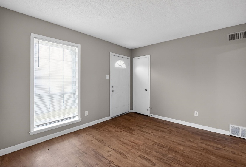 Foyer entrance with dark wood finished floors and a textured ceiling