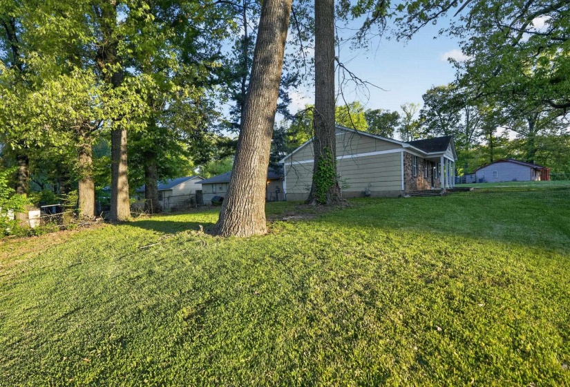 View of yard with view of wooded area