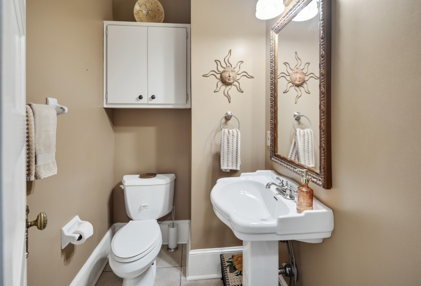 Bathroom with toilet and light tile patterned flooring