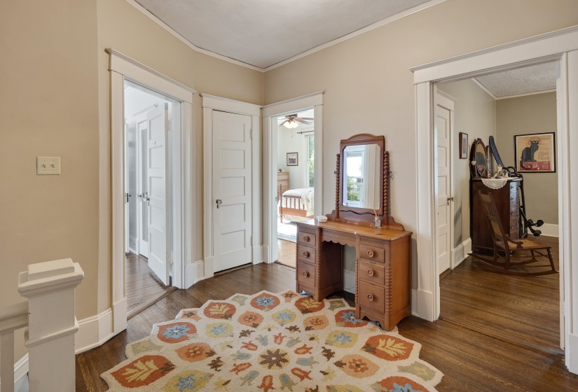 Foyer featuring ornamental molding and dark wood-style flooring