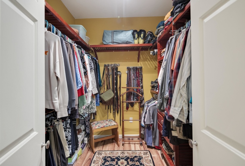 Walk in closet with light wood-style floors