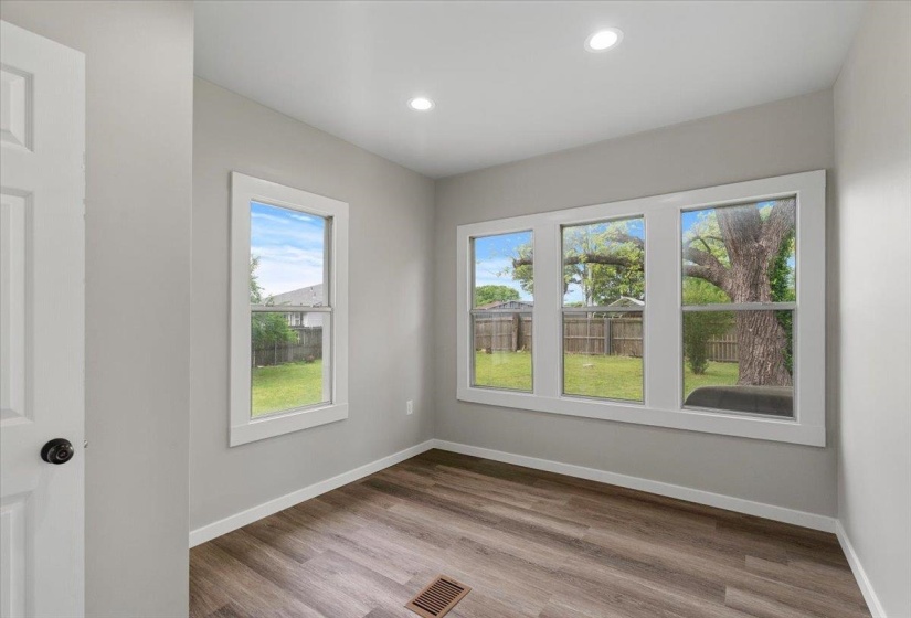 Spare room featuring wood finished floors and recessed lighting