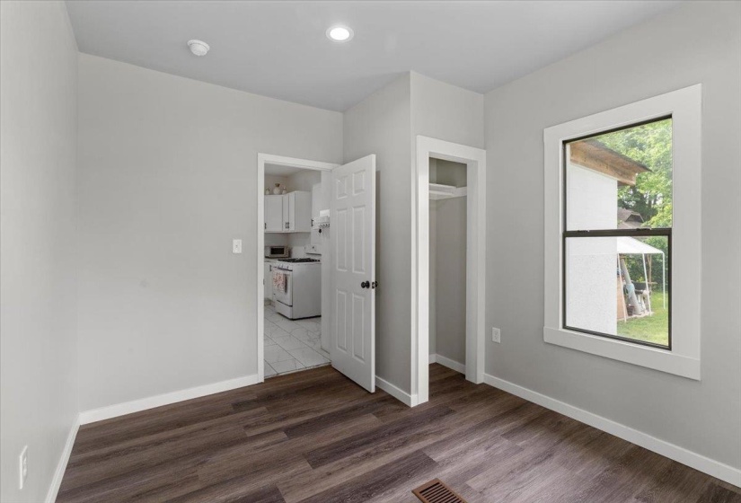 Unfurnished bedroom with dark wood-type flooring and a closet