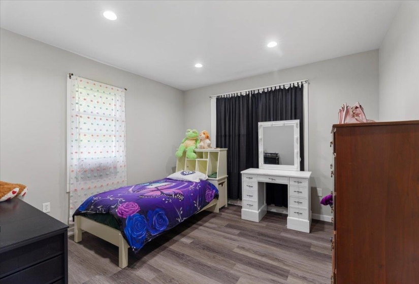 Bedroom featuring dark wood-style flooring and recessed lighting