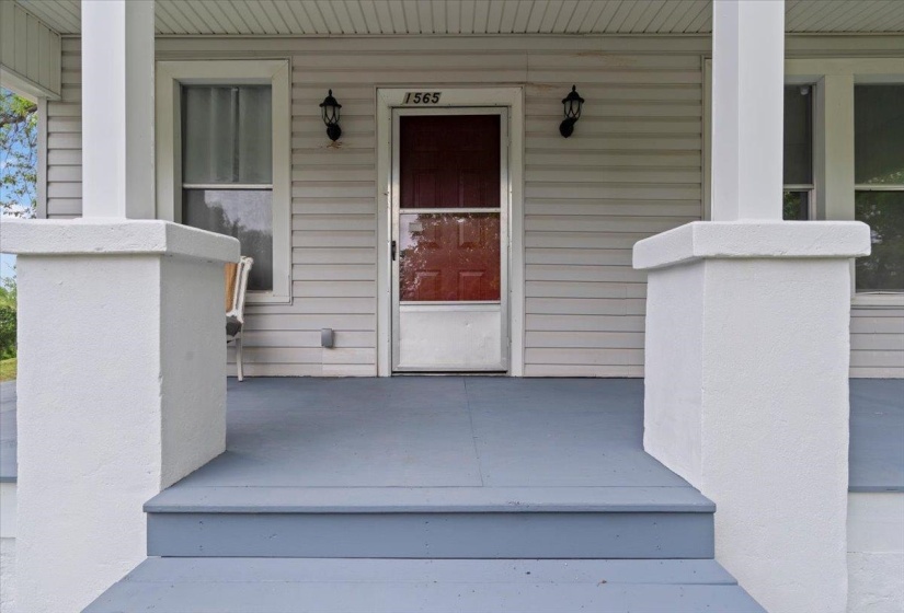 Doorway to property featuring a porch