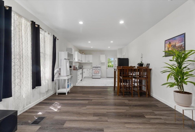 Dining space featuring dark wood-style flooring and recessed lighting