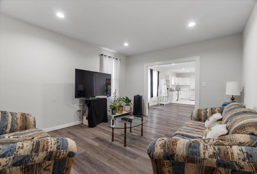 Living room featuring dark wood-style flooring and recessed lighting