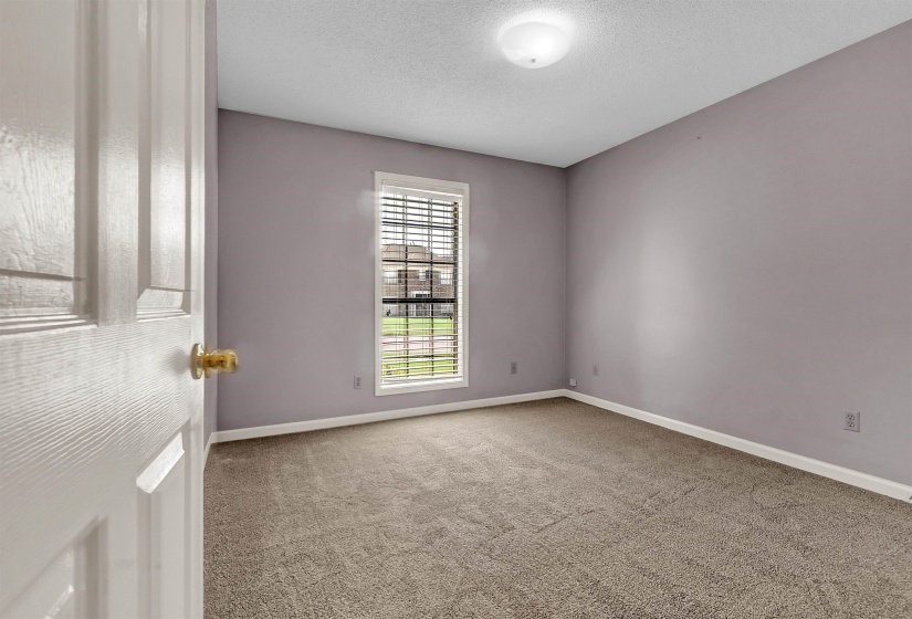 Unfurnished room with light colored carpet and a textured ceiling