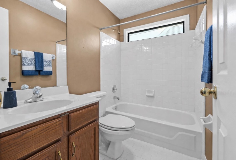 Full bath featuring vanity, bathing tub / shower combination, and light tile patterned floors