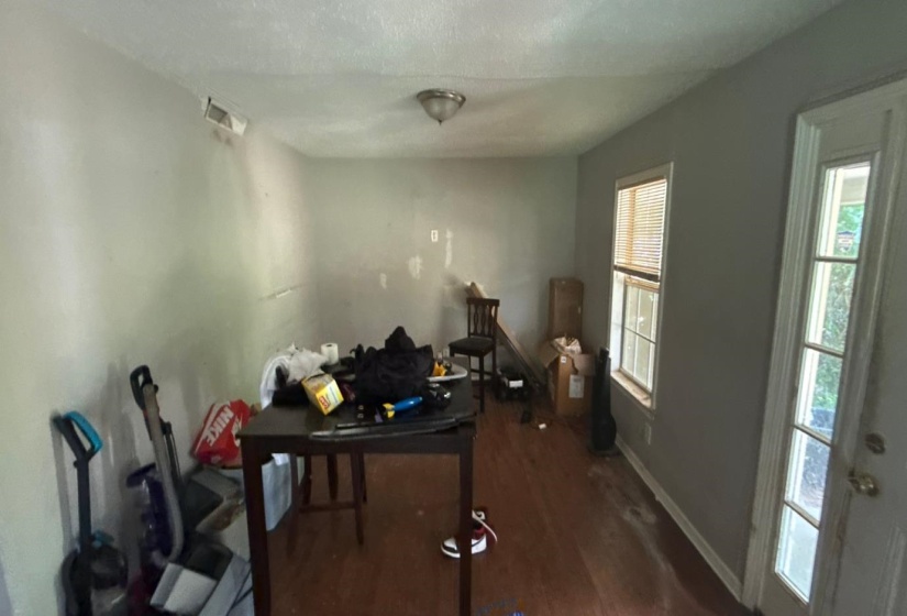 Dining room with dark wood-style floors and baseboards