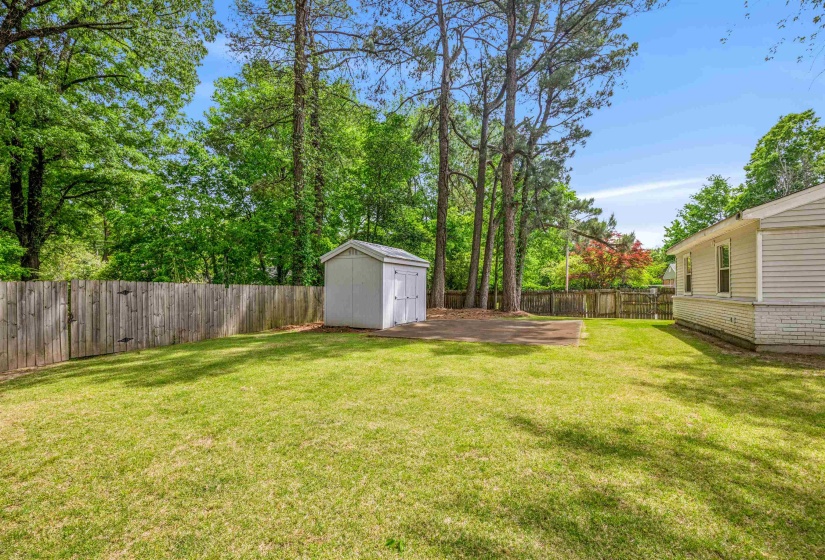 Fenced backyard with a storage shed