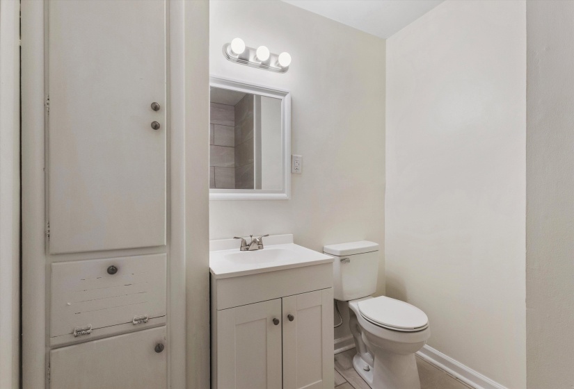 Half bath featuring vanity and light tile patterned flooring