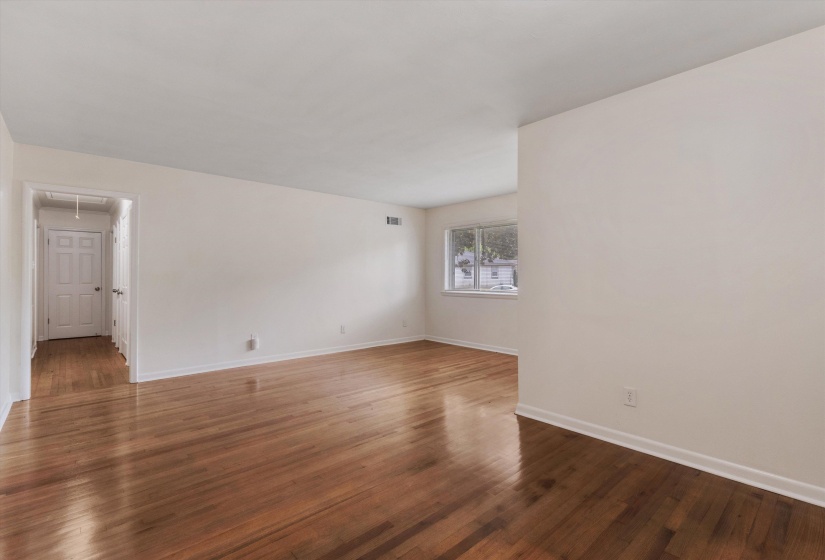 Empty room with dark wood finished floors and attic access