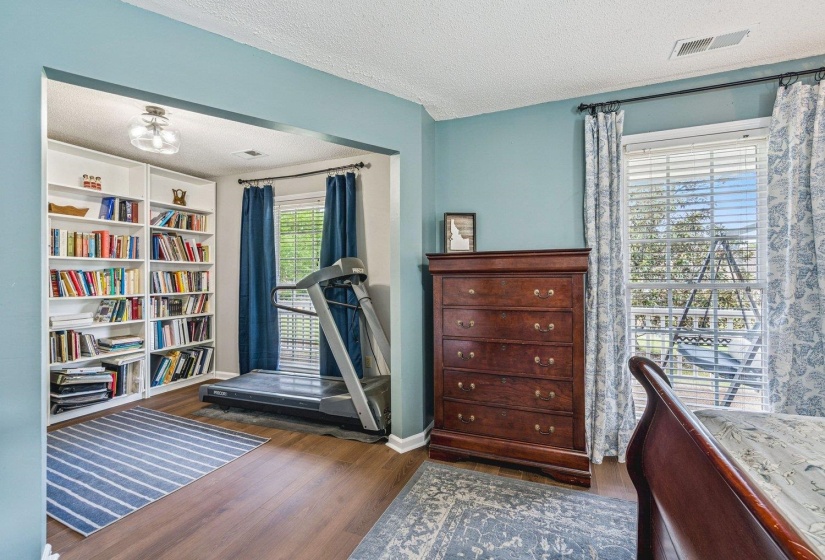 Bedroom with dark wood-style floors and a textured ceiling