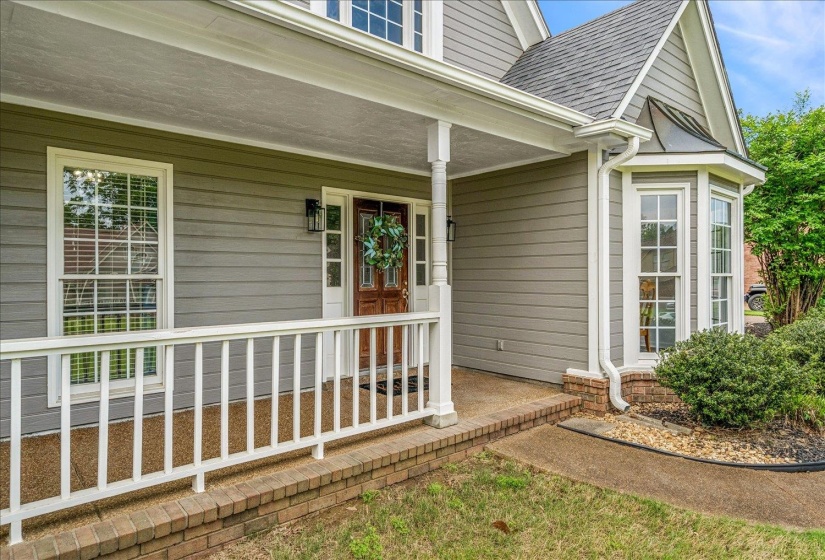 Property entrance featuring a porch and a shingled roof