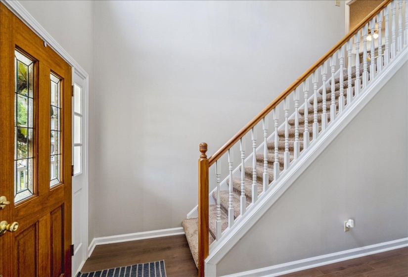 Entrance foyer featuring dark wood-style floors