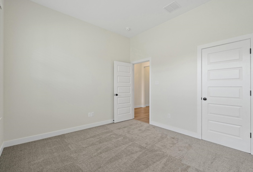 Carpeted interior space featuring light-toned walls and white trim