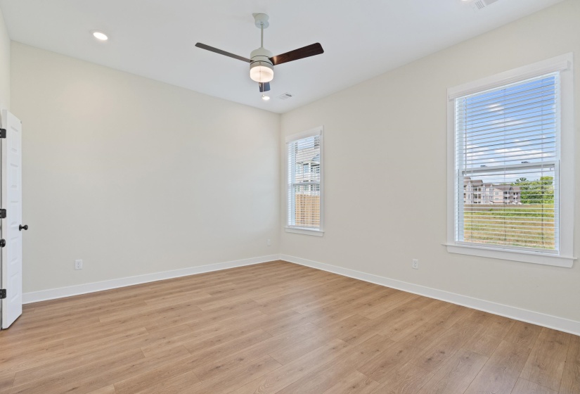 Bright room with wood-finish flooring and neutral wall tones
