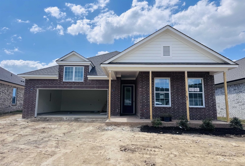View of front of house with brick siding and driveway