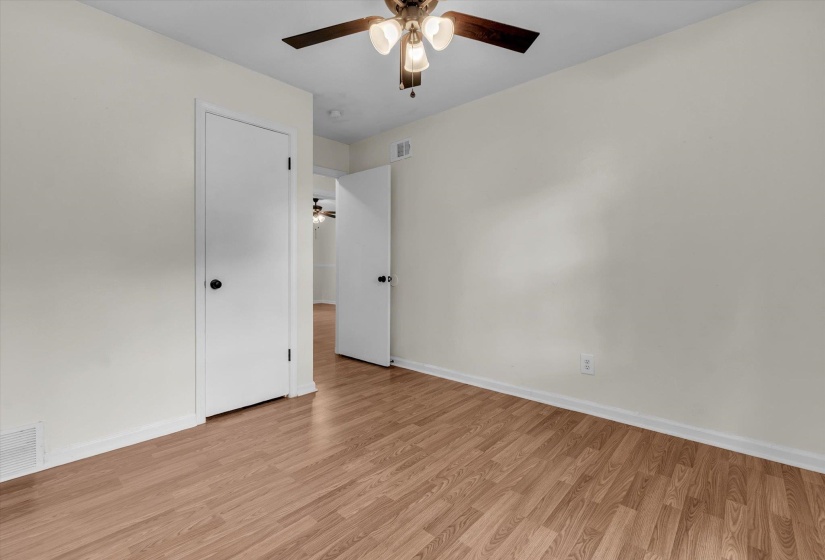 Unfurnished bedroom featuring light wood-style floors and a ceiling fan