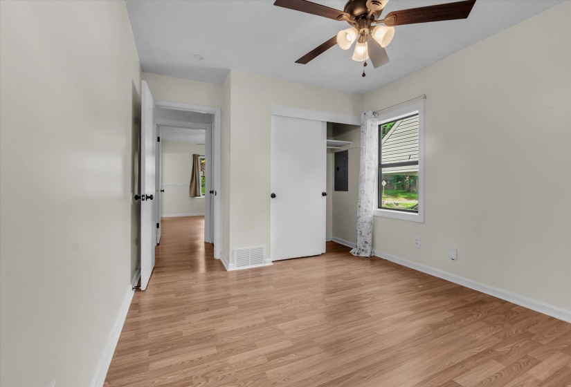 Unfurnished bedroom with light wood finished floors, a closet, ceiling fan