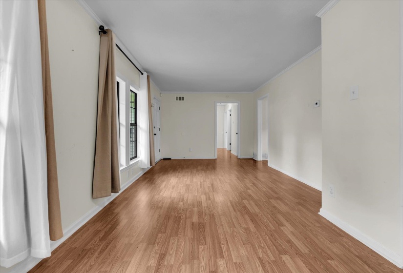 Unfurnished room with crown molding and light wood finished floors
