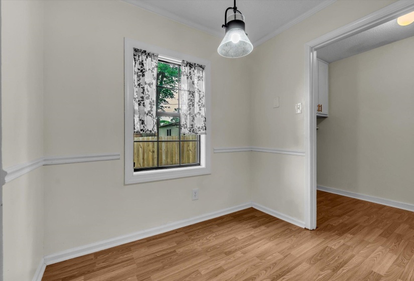 Unfurnished dining area featuring light wood-style floors and ornamental molding