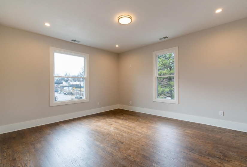 Unfurnished room with recessed lighting and dark wood-style flooring