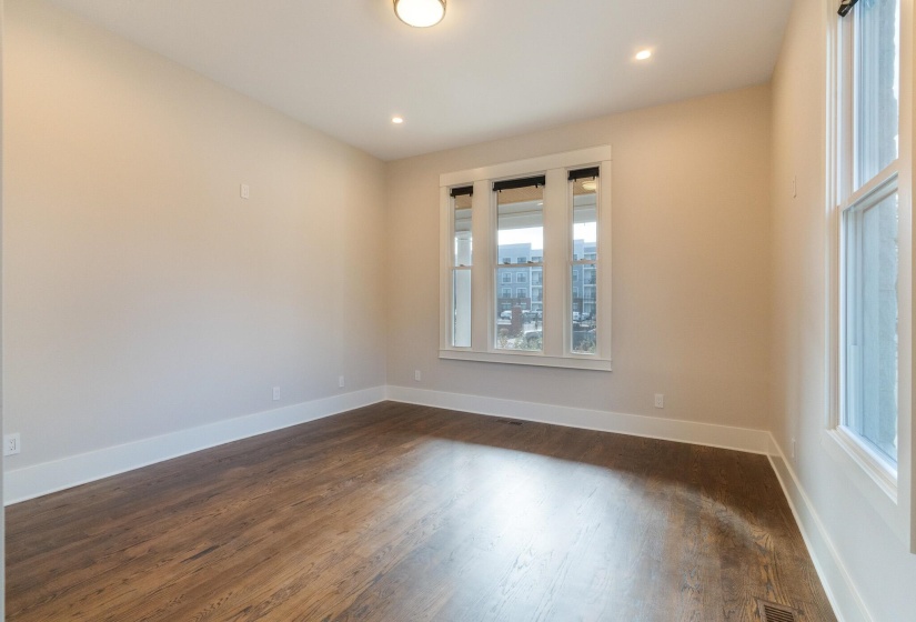 Unfurnished room with dark wood-type flooring and recessed lighting