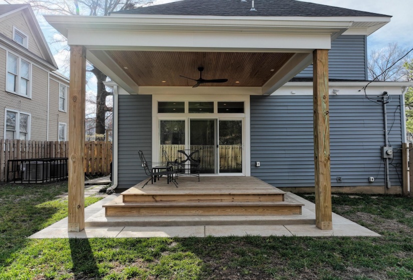 Back of property featuring a ceiling fan, a shingled roof, and a wooden deck