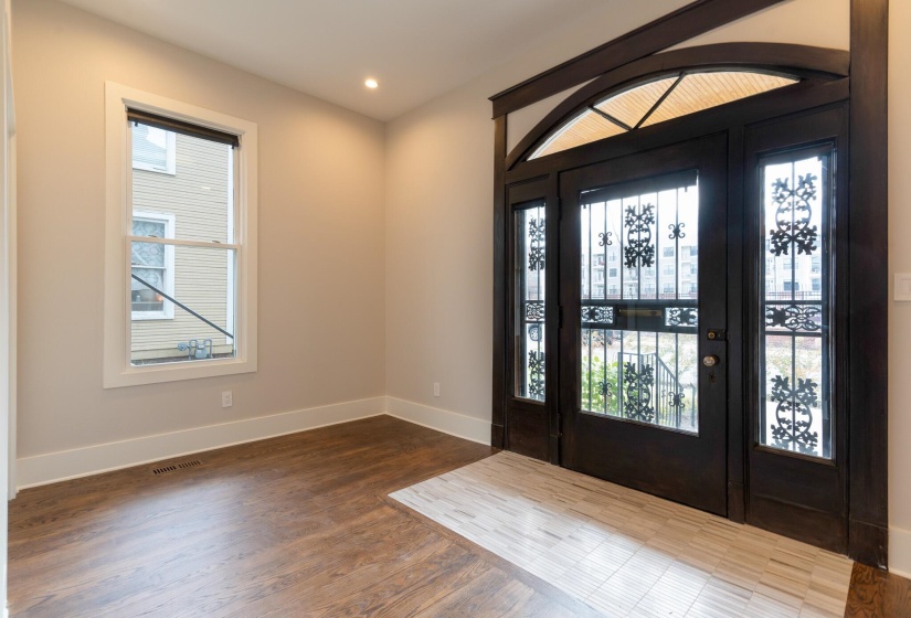 Foyer with dark wood-style floors and recessed lighting