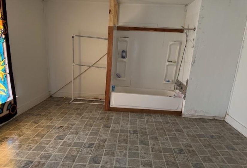 Bathroom featuring baseboards and bathtub / shower combination