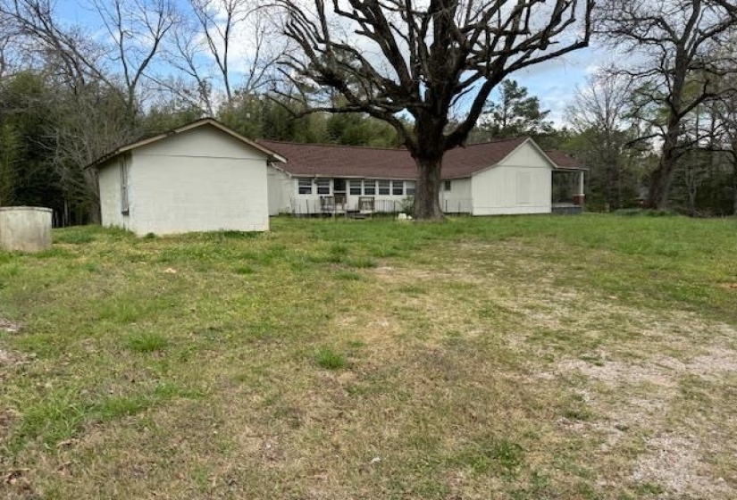 Rear view of property with a lawn