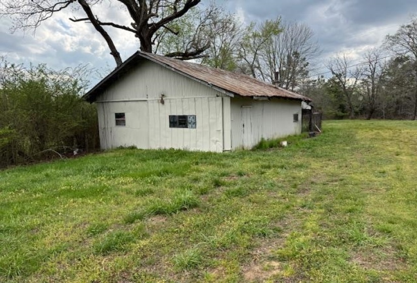 View of pole building with a yard