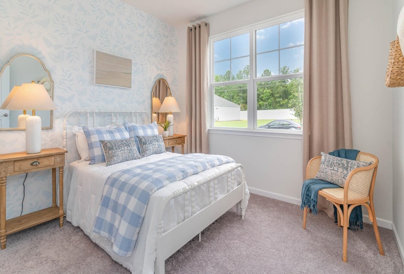 Carpeted bedroom featuring baseboards