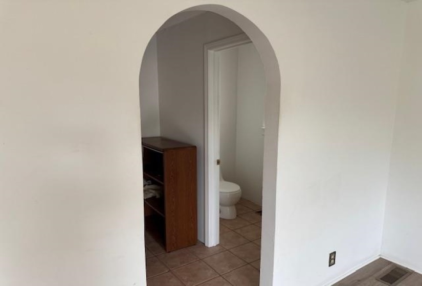 Bathroom with toilet and light tile patterned floors
