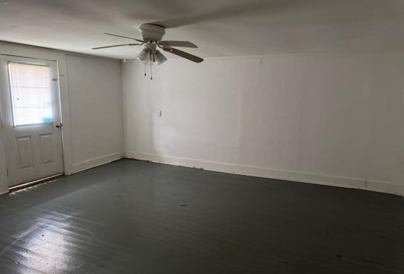 Empty room with a ceiling fan and baseboards