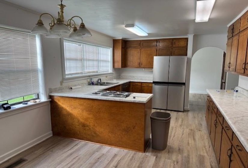 Kitchen featuring wood finish cabinetry, light countertops, and a peninsula